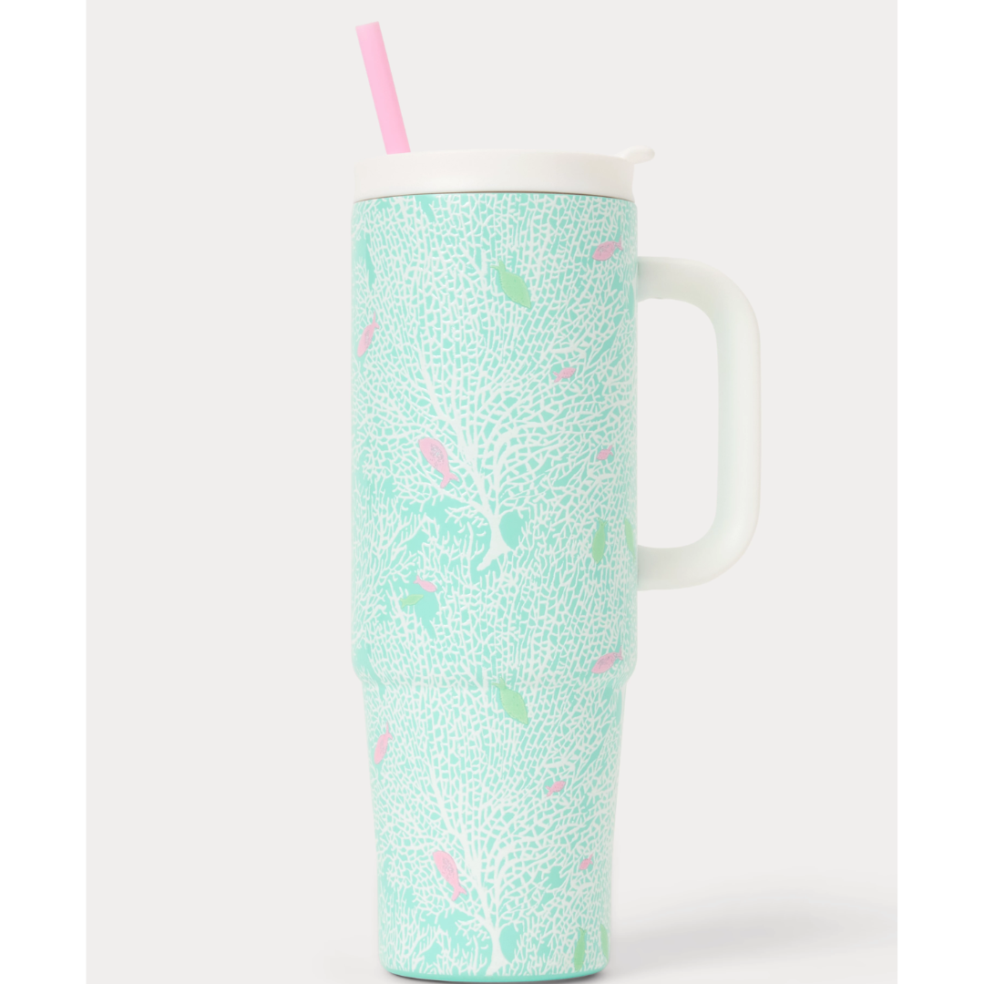 A tall handled travel tumbler with a white lid and straw, decorated with a white coral reef and fish pattern on a mint green background.