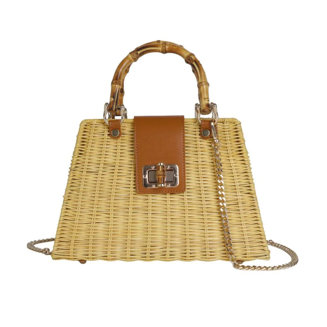 Wicker handbag with brown leather accents and a chain strap on a white background