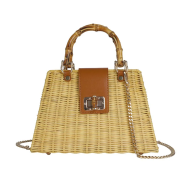 Wicker handbag with brown leather accents and a chain strap on a white background