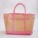 Woven handbag with pink trim on a white background