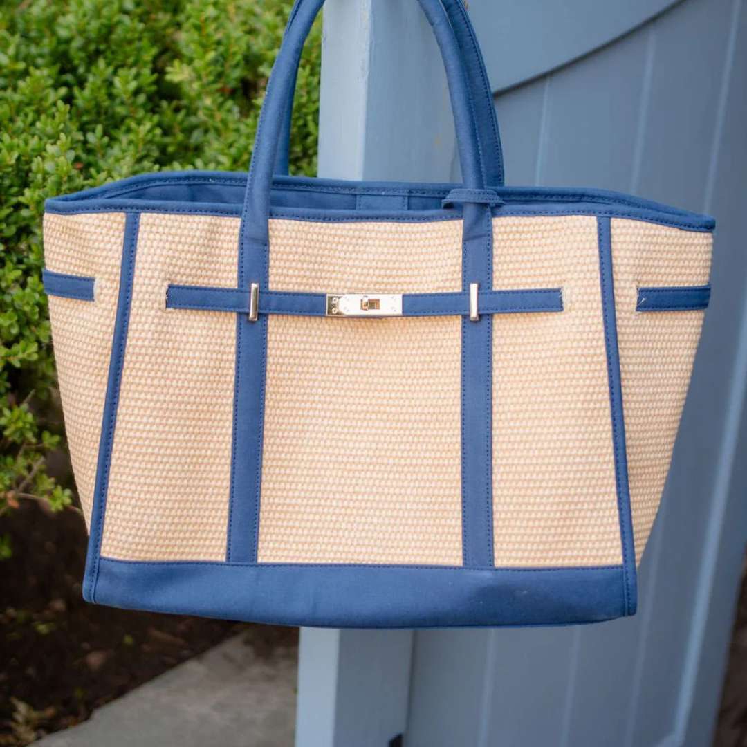 Blue and beige tote bag hanging on a blue door