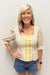 woman wearing yellow and white striped blouse with pattern detail