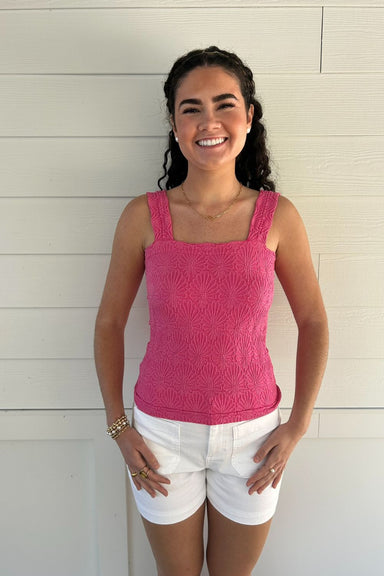 woman in textured pink tank top with white background
