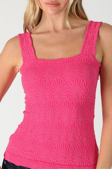 Pink textured tank top worn by a model on a plain background