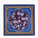 A square silk scarf from the brand Sable des Arts, featuring an intricate floral design. The color palette consists of a deep royal blue border, a gold geometric frame, a central dark plum purple section, and light blue and white floral motifs.