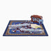 A Mahjong set displayed on a blue patterned game mat, with several clear acrylic tile holders, a brown carrying case, a blue score card, and game accessories arranged on a white background.