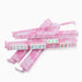 Pink marble-patterned mahjong tile racks with several sample mahjong tiles displayed on them, set against a plain white background.