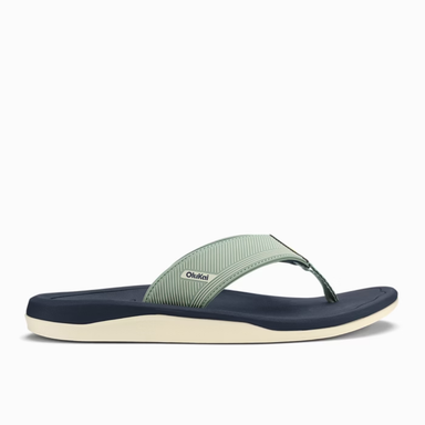 Green and navy sandal with 'OluKai' branding on a white background