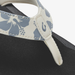 Close-up of a sandal with floral strap design on a white background