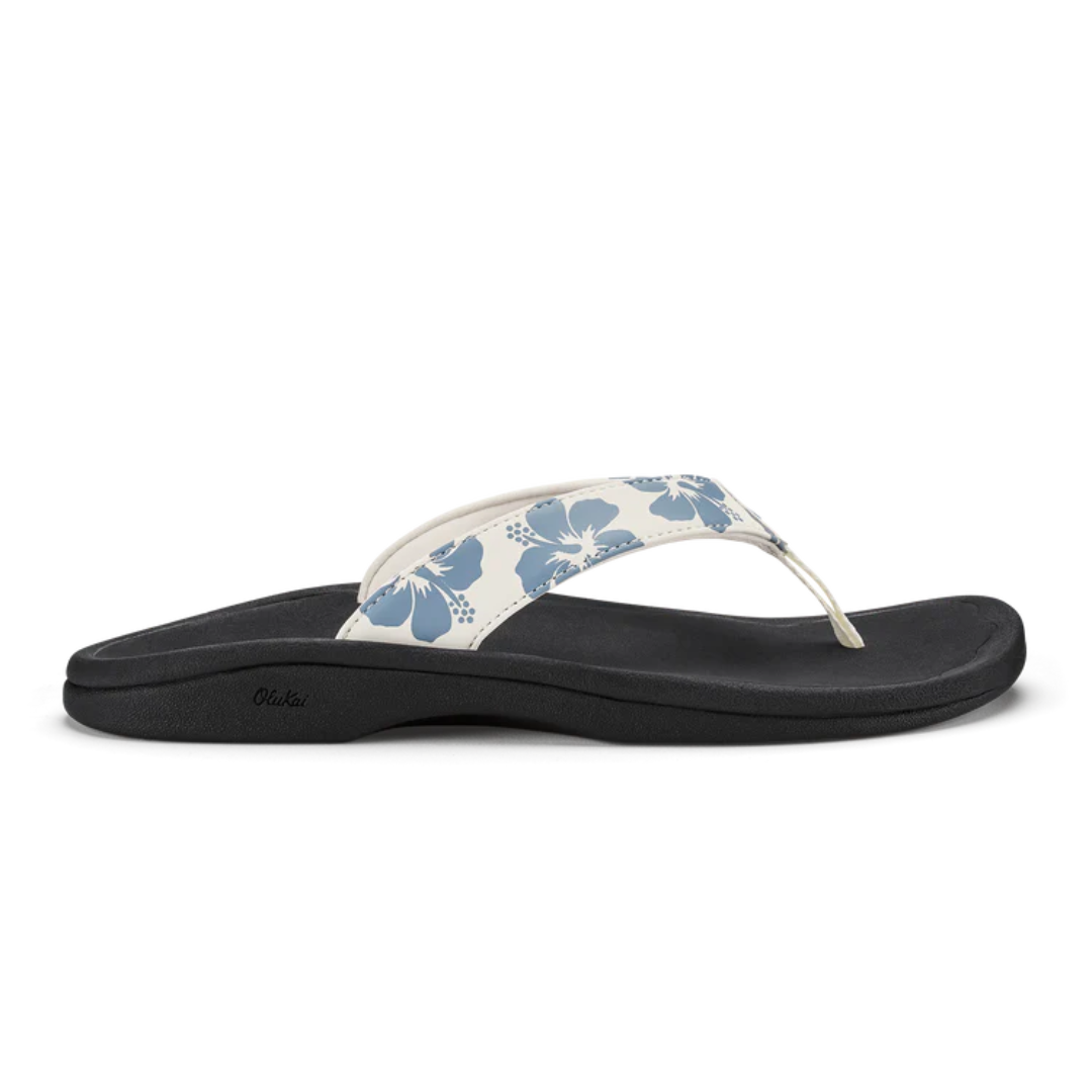 Black sandal with blue floral design on a white background