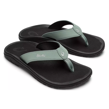 Pair of green and black sandals on a white background