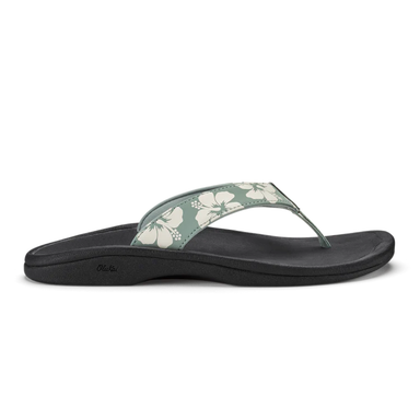 Black sandal with floral strap on a white background