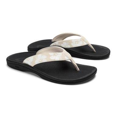 Pair of black and beige sandals on a white background