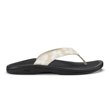 Black sandal with a white floral pattern on a white background