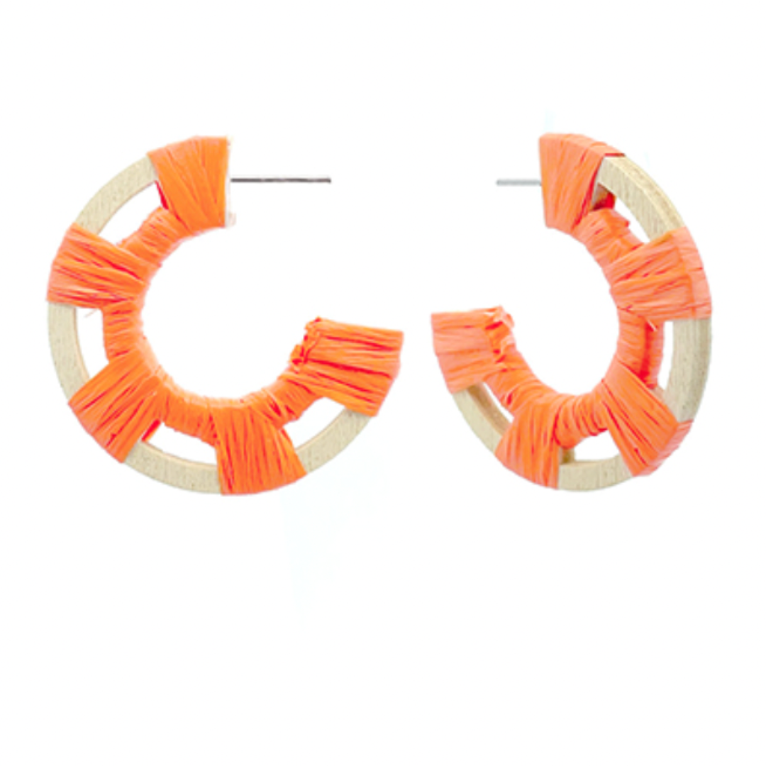 Pair of orange hoop earrings on a white background