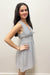 Woman wearing blue and white striped dress with tie bow in front 