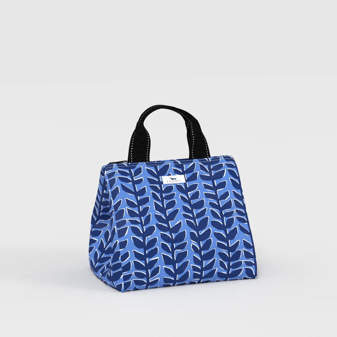 A blue and navy patterned canvas lunch bag with black top handles, shown on a light gray studio background.