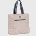 Beige tote bag with black and white striped handles on a light gray background