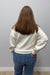 Woman wearing Six Fifty Scuba 1/4 Zip In Cream with blue jeans on a plain white background.