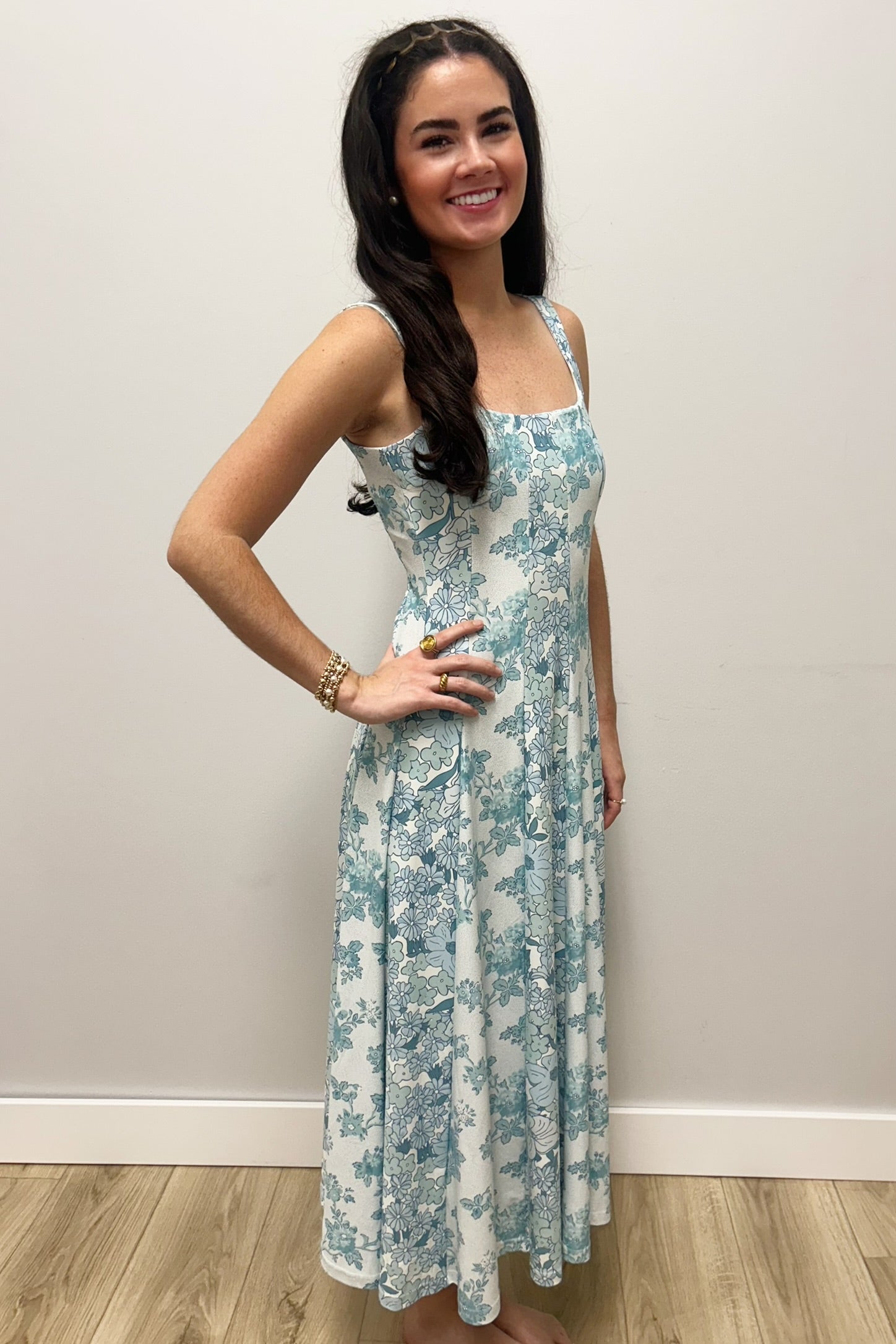 Woman wearing white and blue maxi dress with floral pattern