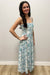 Woman wearing white and blue maxi dress with floral pattern