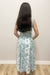 Woman wearing white and blue maxi dress with floral pattern