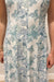 Woman wearing white and blue maxi dress with floral pattern