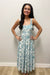 Woman wearing white and blue maxi dress with floral pattern