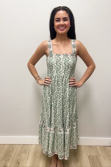 Woman wearing white dress with green floral pattern