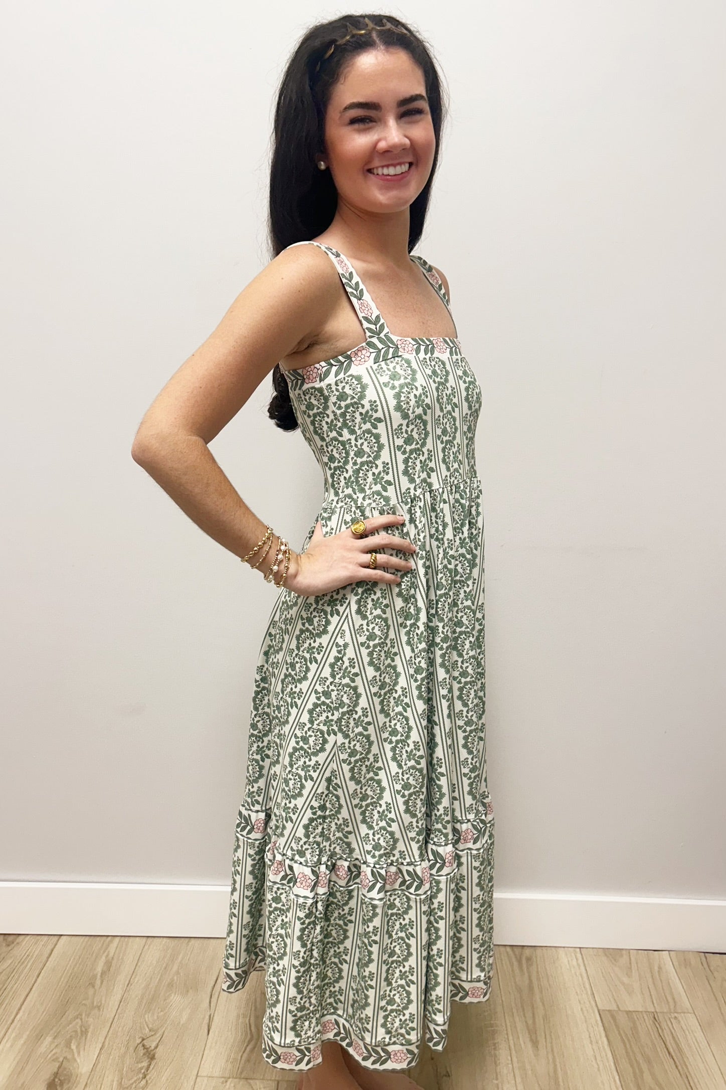 Woman wearing white dress with green floral pattern