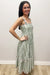 Woman wearing white dress with green floral pattern