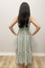 Woman wearing white dress with green floral pattern