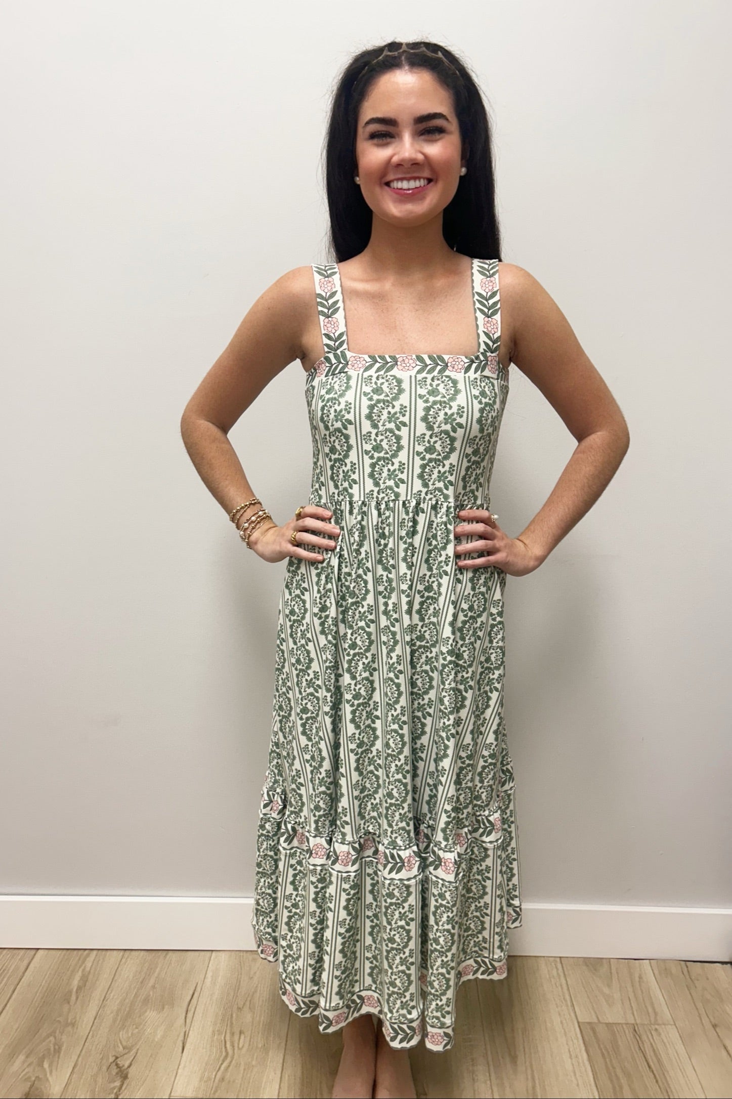 Woman wearing white dress with green floral pattern