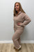 Woman wearing Softies Cable Knit Marshmallow 1/2 Zip with Tapered Pant Coco on a plain white background.