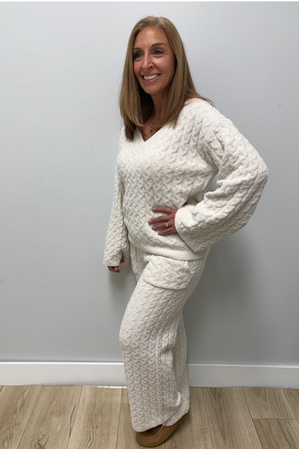 Woman wearing Softies Cable Knit Marshmallow V-Neck with Flared Sleeve and Pant Almond on a plain white background.