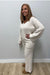 Woman wearing Softies Cable Knit Marshmallow V-Neck with Flared Sleeve and Pant Almond on a plain white background.