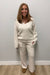 Woman wearing Softies Cable Knit Marshmallow V-Neck with Flared Sleeve and Pant Almond on a plain white background.