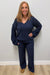 Woman wearing Softies Cable Knit Marshmallow V-Neck with Flared Sleeve and Pant Midnight on a plain white background.