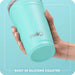 Hand holding a turquoise Swig tumbler with a built-in silicone coaster on a light blue background.