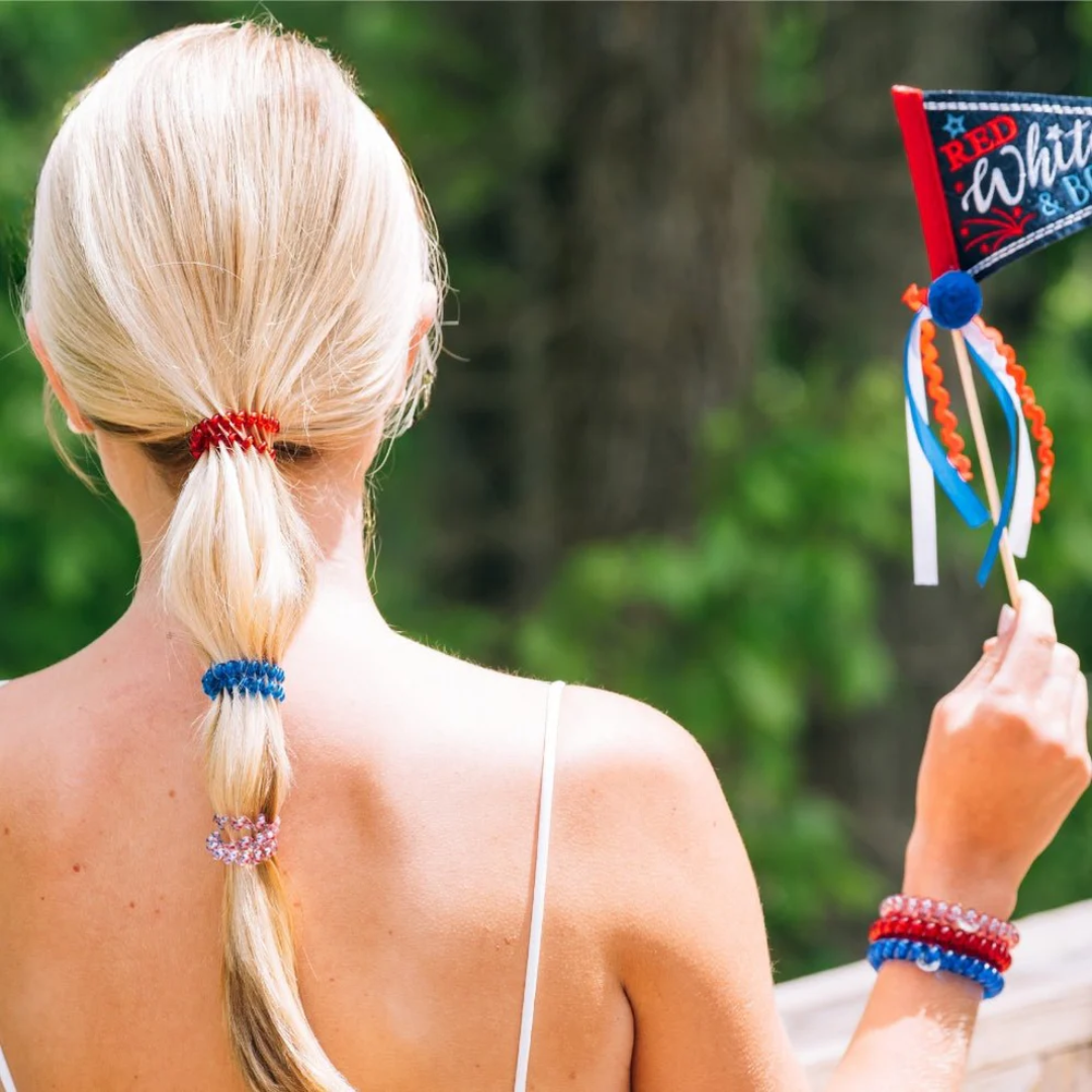 model wearing hair ties holding flag against nature background