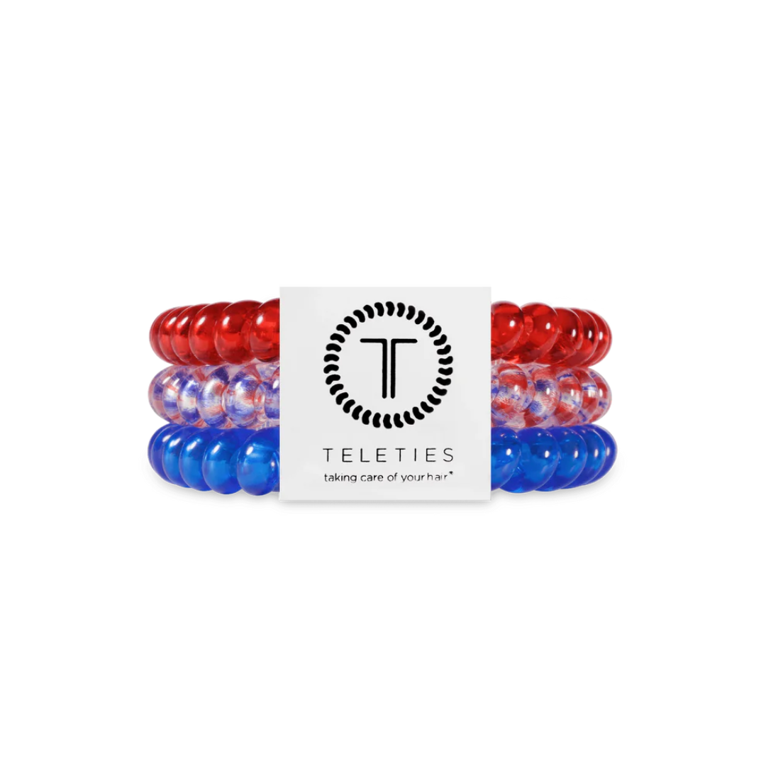red white and blue hair ties against white background