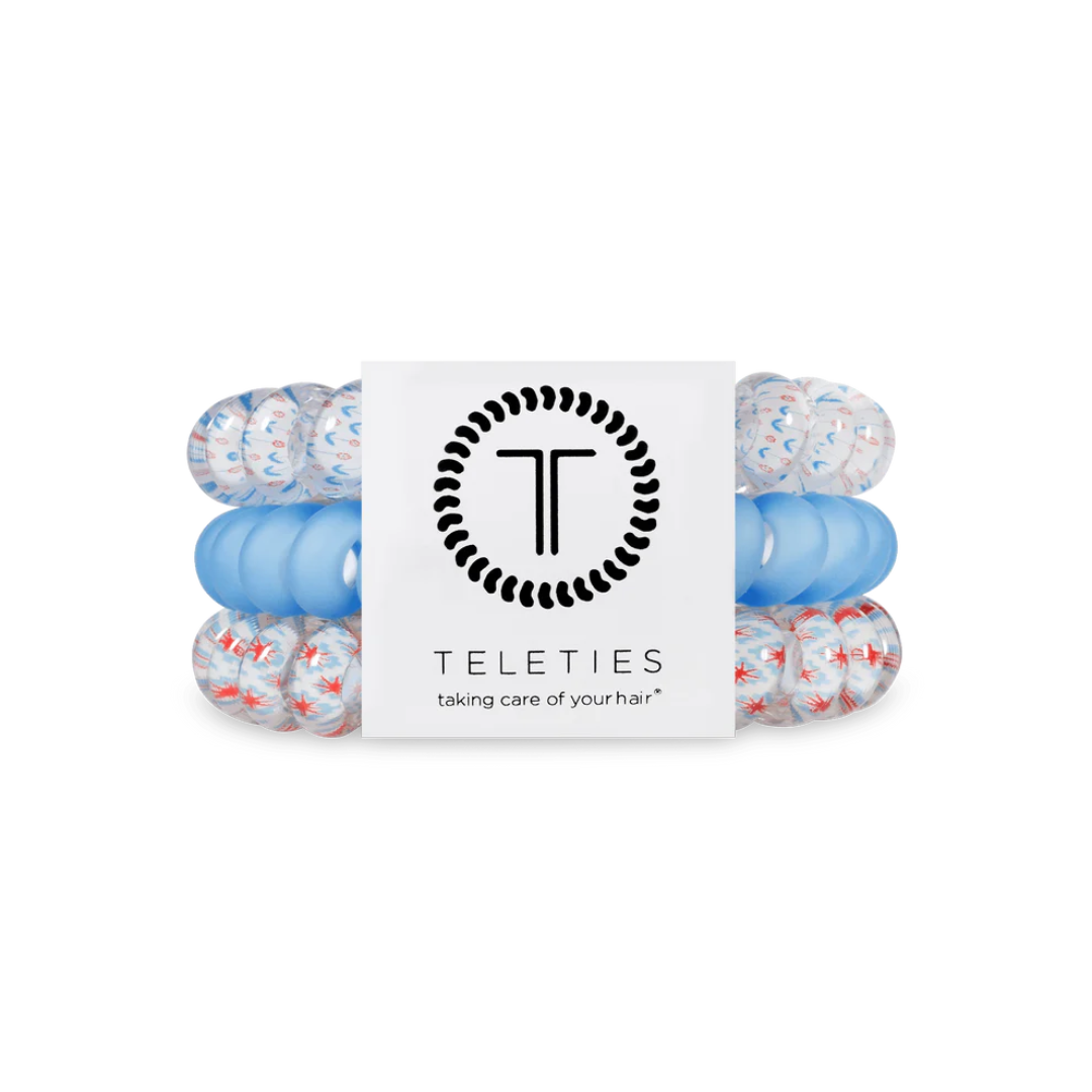 group of red white and blue hair ties on white background 
