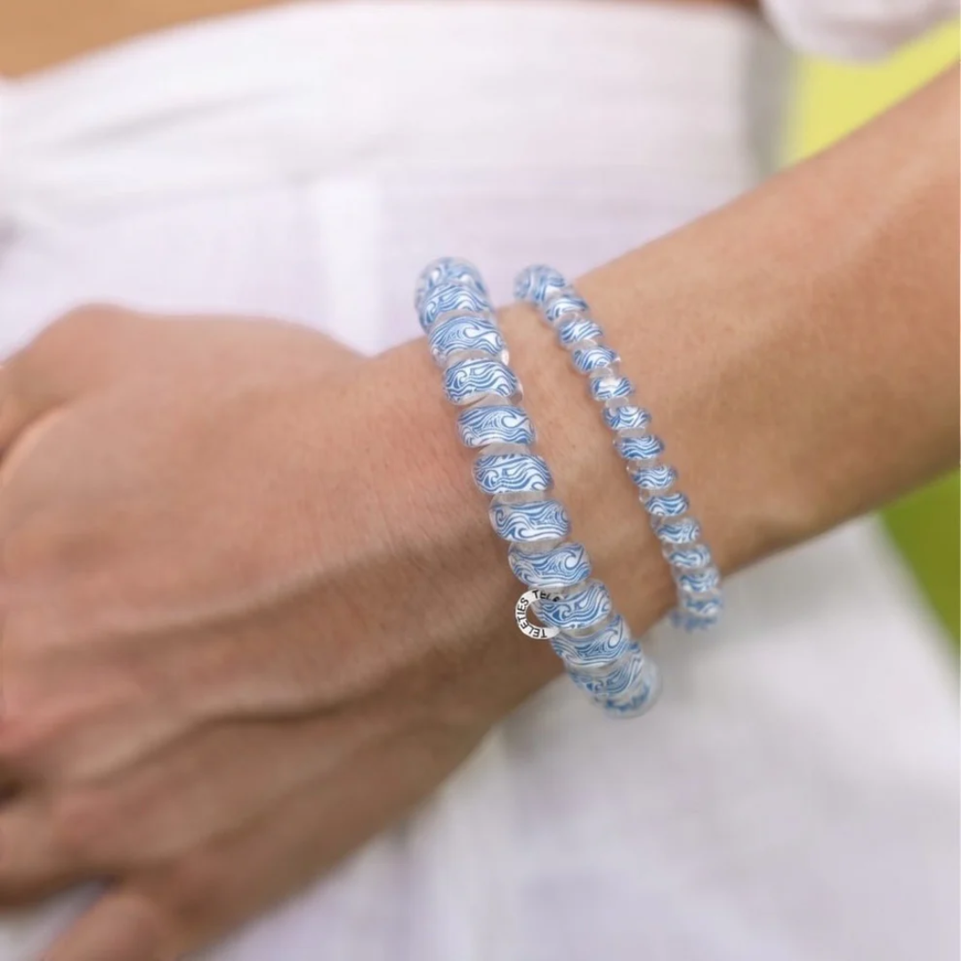 blue hair ties on wrist of model