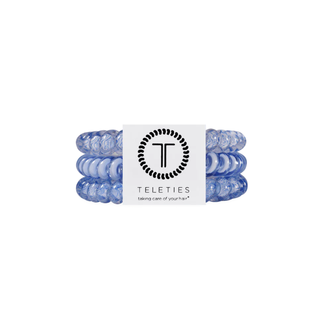 blue hair ties on white background