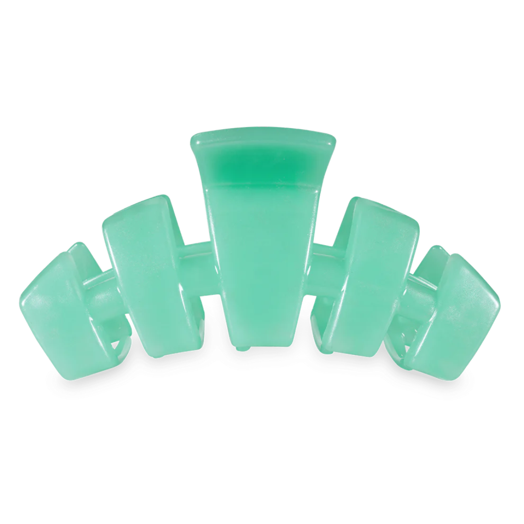 green hair clip against white background