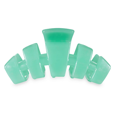 green hair clip against white background
