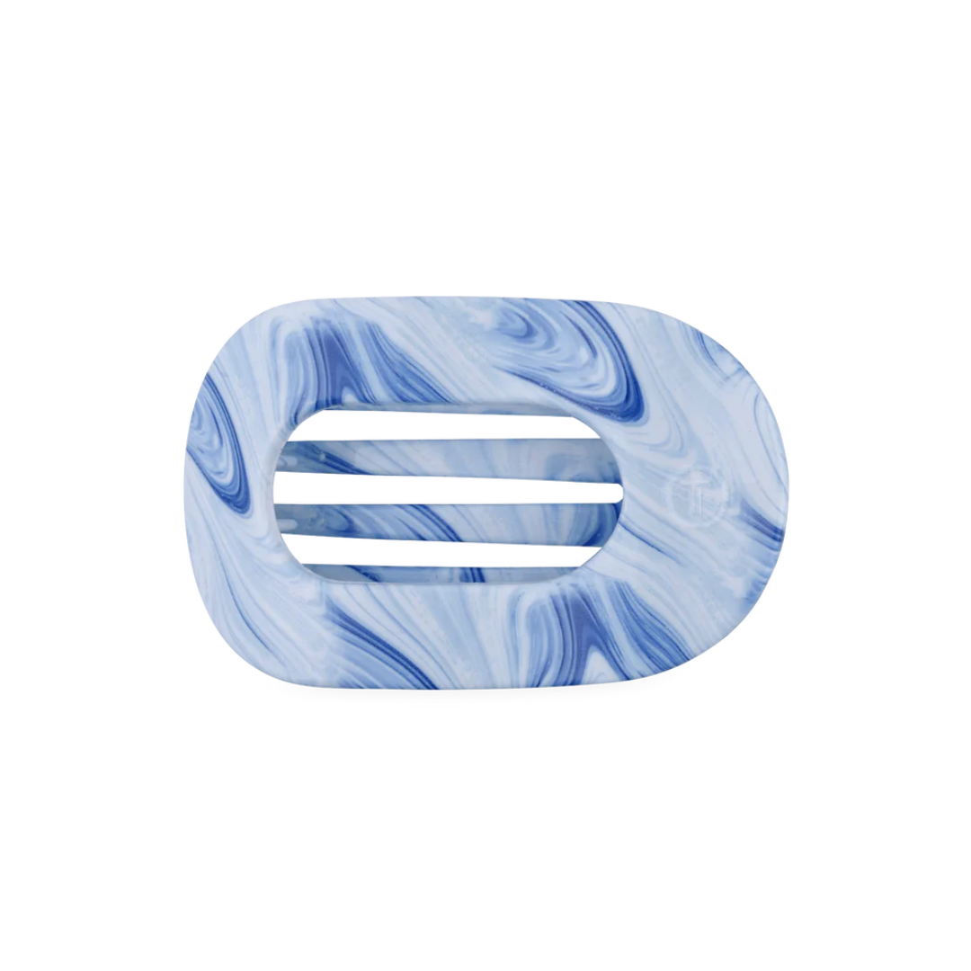 Marble-patterned hair clip with blue and white swirls on a white background