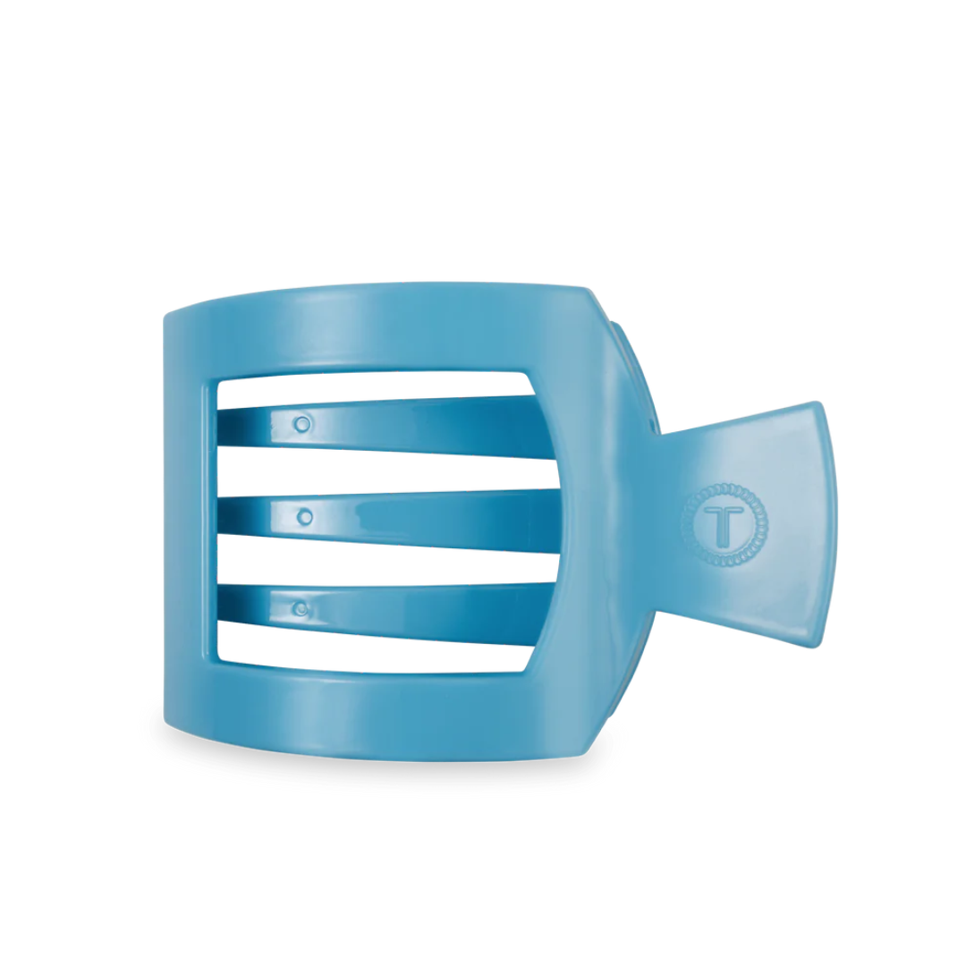 Blue plastic cup with white stripes on a white background