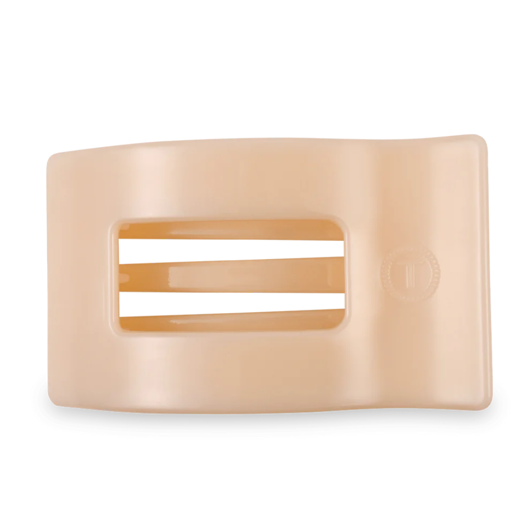 cream hairclip against white background