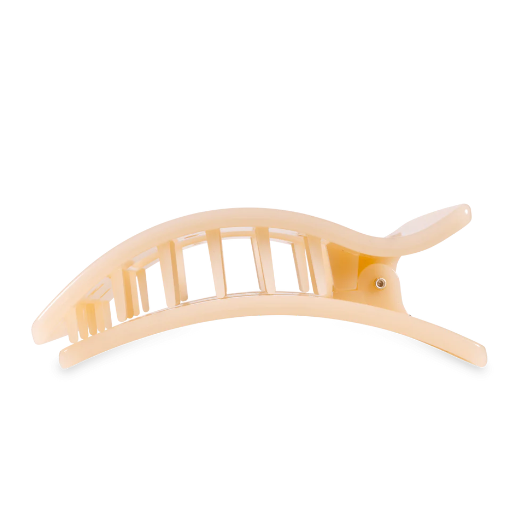 cream hairclip against white background